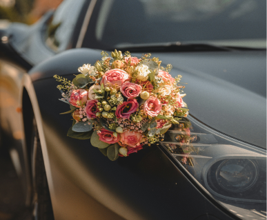 Bridal bouquet resting on a car bonnet
